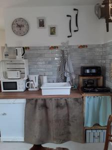 a kitchen with a counter with a sink and a microwave at Ferienhaus mit Minibauernhof in Munster im Heidekreis