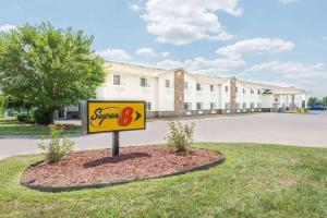 a sign in the grass in front of a building at Super 8 by Wyndham Platte City Kansas City Area in Platte City
