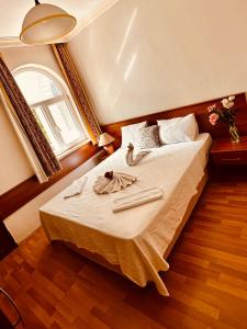 a bedroom with a bed with two towels on it at Felicity Hotel & Bungalows in Kemer