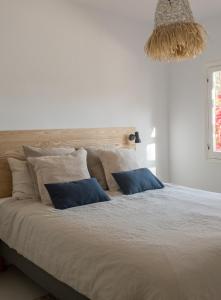 a bedroom with a large bed with blue pillows at Spacious & Luxury villa in centre Ibiza in Santa Gertrudis de Fruitera