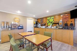 a fast food restaurant with two tables and a counter at La Quinta by Wyndham El Paso East in El Paso