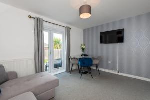 a living room with a couch and a table at Grange Way in Bowburn