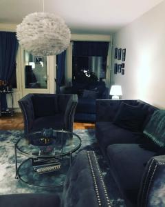 a living room with a couch and a glass table at Jane’s place in Stockholm
