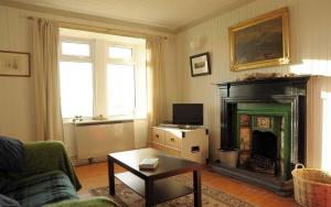 a living room with a fireplace and a couch at 21 Upper Edinbane in Edinbane