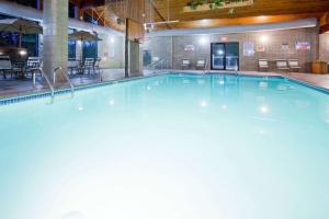 a large swimming pool in a building at AmericInn by Wyndham New Richmond in New Richmond