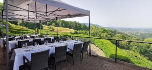 ein Restaurant mit weißen Tischen und Stühlen auf einem Balkon in der Unterkunft Burg Windeck ***S in Bühl