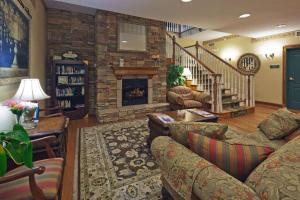 a living room with a couch and a fireplace at Wingate By Wyndham in Mansfield