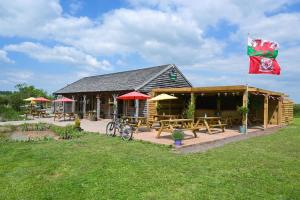 a building with tables and a flag on it at 1-Bed pod cabin in beautiful surroundings Wrexham in Wrexham