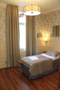 a bedroom with a bed and a large window at Hotel Kruunupuisto in Punkaharju +40 photos