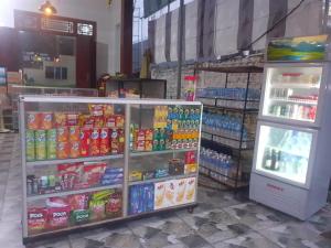 a grocery store with a refrigerator and some drinks at Hoan Chau Homestay in Phong Nha