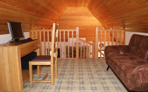 a living room with a couch and a tv at Fairy Glen Cottage in Uig