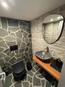 a bathroom with a sink and a mirror at Palorto Traditional Hotel in Gjirokastër