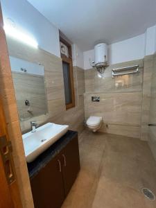 a bathroom with a sink and a toilet at Fantastic Three Bedroom Apartment in Shimla