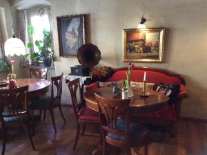 a living room with two tables and a couch at Hotel Gerberhaus in Rothenburg ob der Tauber