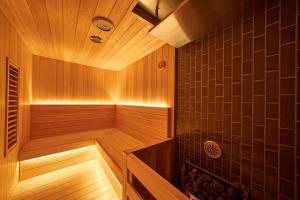 a wooden sauna with a wooden floor and brown walls at WeBase KAMAKURA in Kamakura