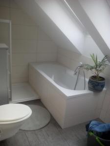 a bathroom with a white tub and a toilet at Ferienwohnung am Teupitzsee in Teupitz