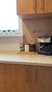 a kitchen with a counter top with a coffee maker at Bresno8 in Gdańsk