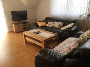 a living room with two couches and a coffee table at Ferienwohnung Arnika 