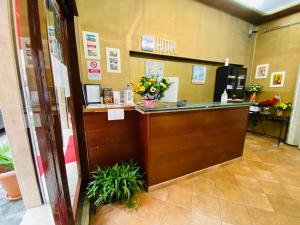 a lobby with a counter with flowers on it at Hotel Beauty Palace - Vertex Group in Rome