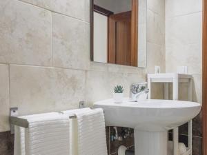 a bathroom with a white sink and a mirror at Alcalá del Rio! bajo A in Alcalá del Río +32 photos