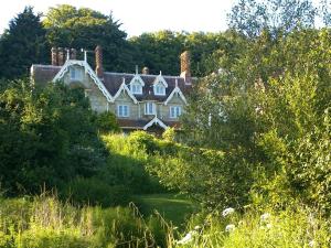 a large house sitting in the middle of a field at Lisle Combe in Ventnor