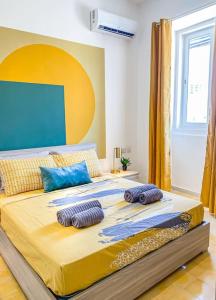 a bedroom with a large bed with two pillows on it at First floor 2 bedroom Modern Apartment in Gzira 3 in Il-Gżira