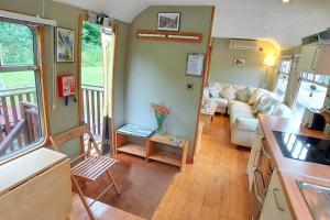 a living room with a couch and a table at Carriage 2 - Coalport Station Holidays in Telford