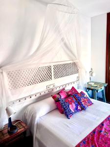 a white bed with two pillows on top of it at Garay Apartments in Benidorm