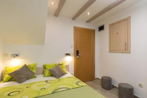 a bedroom with a large bed with yellow pillows at Central Old Town Apartments in Dubrovnik