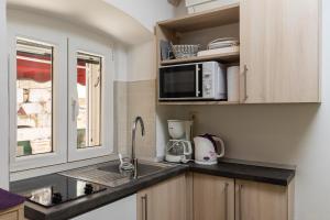 a kitchen with a sink and a microwave at Central Old Town Apartments in Dubrovnik