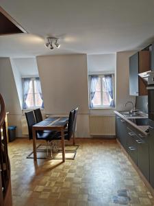 a kitchen with a table and chairs in a room at Apartment am Zolltor in Wertheim