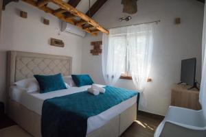 a bedroom with a bed with a teddy bear on it at Holiday Home Moliva in Donje Sitno +57 photos