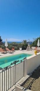 a swimming pool with a fence next to at Peiranze144 b&b in Sanremo