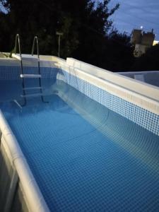 a swimming pool with blue tiles on top of it at Queens Luxury Glamping in Palaiokastro +85 photos