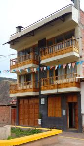 a building with wooden balconies on the side of it at La Casa de la Abuela I in Yucay