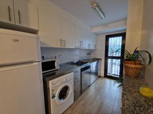 a kitchen with a washer and dryer in it at BeachSide Apartments Peñiscola in Peniscola