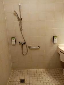 a bathroom with a shower and a sink at Kyriad Chantilly in Chantilly