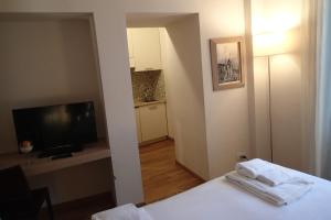 a hotel room with a bed and a television and a room at Relais Piazza Signoria in Florence