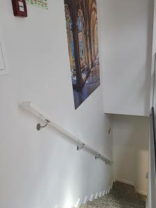 a painting hanging on a wall next to a shelf at Alojamento Local Vitoria in Batalha
