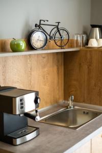 a kitchen with a sink and a bike on a shelf at Villa Pino in Velingrad