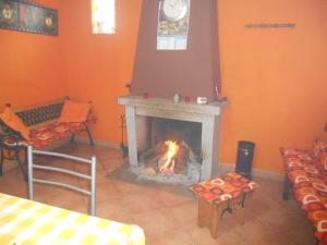 a fireplace in a living room with a fire place at Casa do Souto in Quinta do Souto