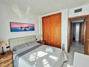 a bedroom with a bed in a room with a window at Seafront apartment in Blanes in Blanes