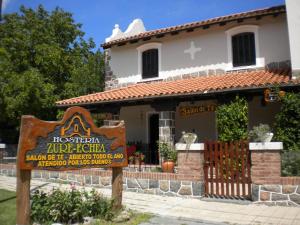 a house with a sign in front of it at Hosteria Zure-Echea in Valle Hermoso