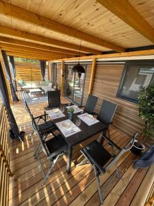 eine Veranda mit einem Tisch und Stühlen auf einer Terrasse in der Unterkunft Mobile Home La Vida in Biograd na Moru