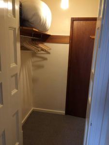 a room with a closet with a bed and a door at Beautiful Apartment in Character Former Rectory in Penrith
