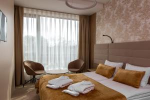 Postel nebo postele na pokoji v ubytování Grand SPA Lietuva Hotel Lietuva