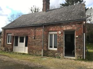 stary ceglany dom z oknem i drzwiami w obiekcie Gîte ch'Armand Rouperroux w mieście Rouperroux