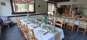 a dining room with white tables and chairs at Le Rookie Mountain in Le Grand-Bornand