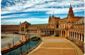 a large building with a canal in front of it at Apartamento luminoso in Seville