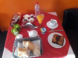 a red table with a tray of food on it at chambre Noix de Coco résidence Chahrazad in Sfax